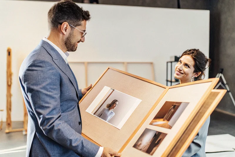 Professional photographer showing a matted album to a client