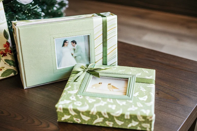 A wedding-themed photo album and matching frame set in a gift box