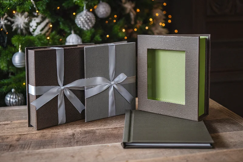 A beautifully packaged gift album with a ribbon, next to a matching photo frame