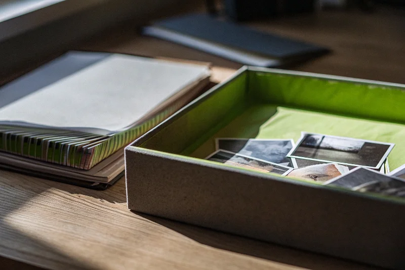 Vintage photos being carefully placed into an archival album