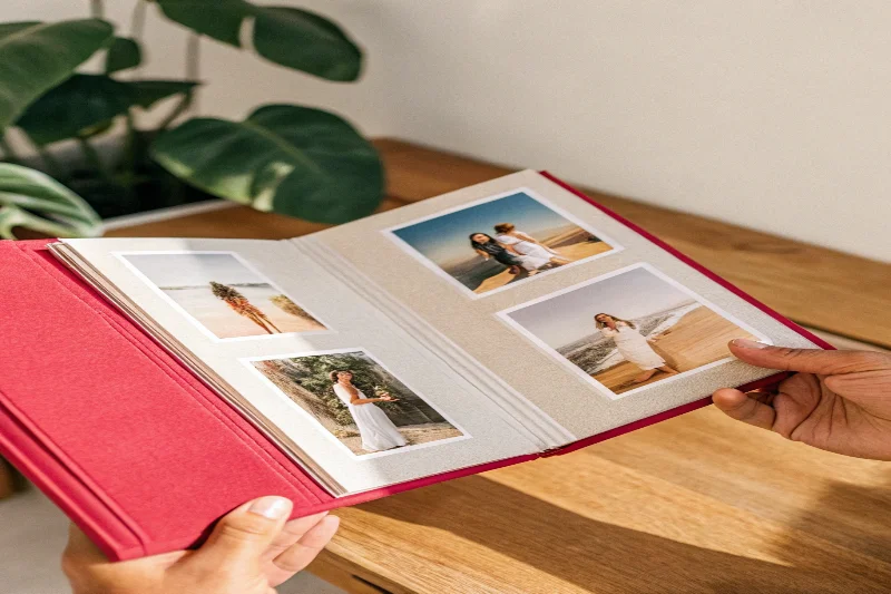 An open photo album displaying large 13x18cm photos