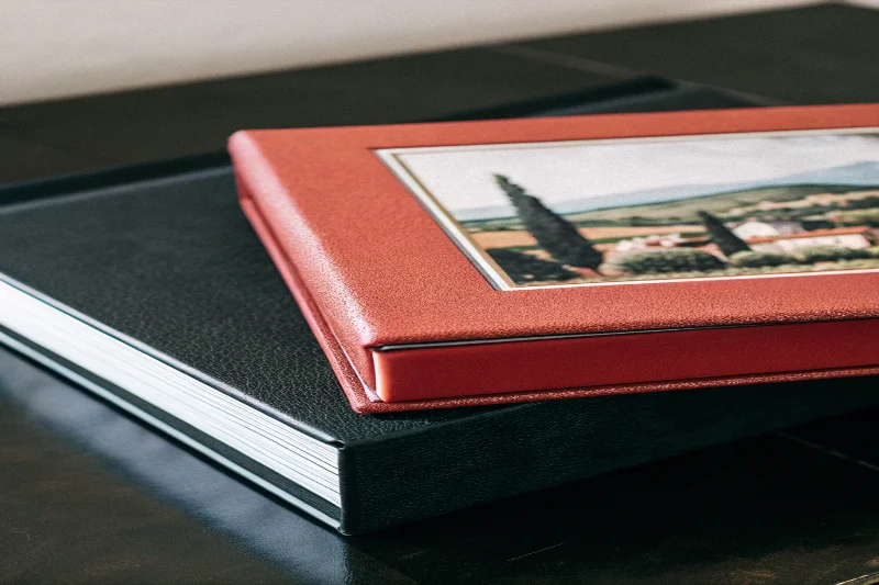 A photo album with a printed cover showing a scenic Italian landscape