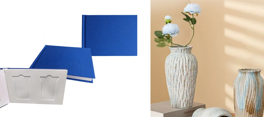Two blue photo albums on a white background, alongside ceramic vases with white flowers on a beige surface.