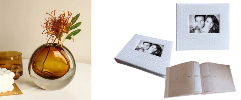 White textured photo album with framed couple photo alongside decorative amber vase and accessories on white surface.