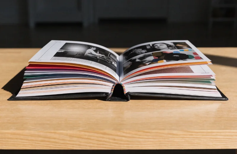 An album laid open perfectly flat on a table