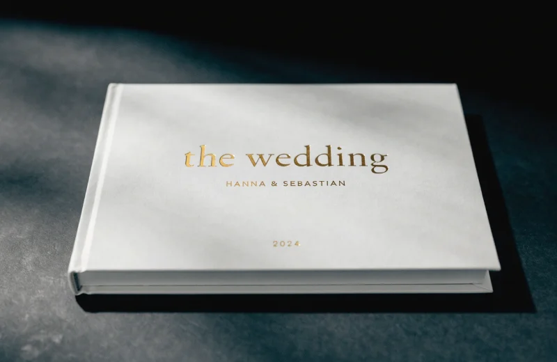 A minimalist wedding album with simple, elegant gold foil text on the cover