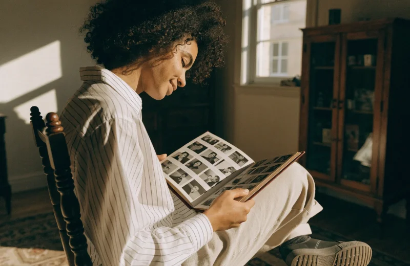 A person looking fondly at a photo album, conveying emotion and value