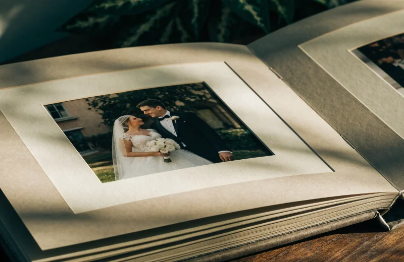 An open matted photo album showing the precision-cut mats around a wedding photo